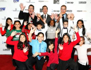 Students pose with Shining Star Honorees Ed Helms (center) and Richard Meyer (left), flanked by host Andy Richter (right). 